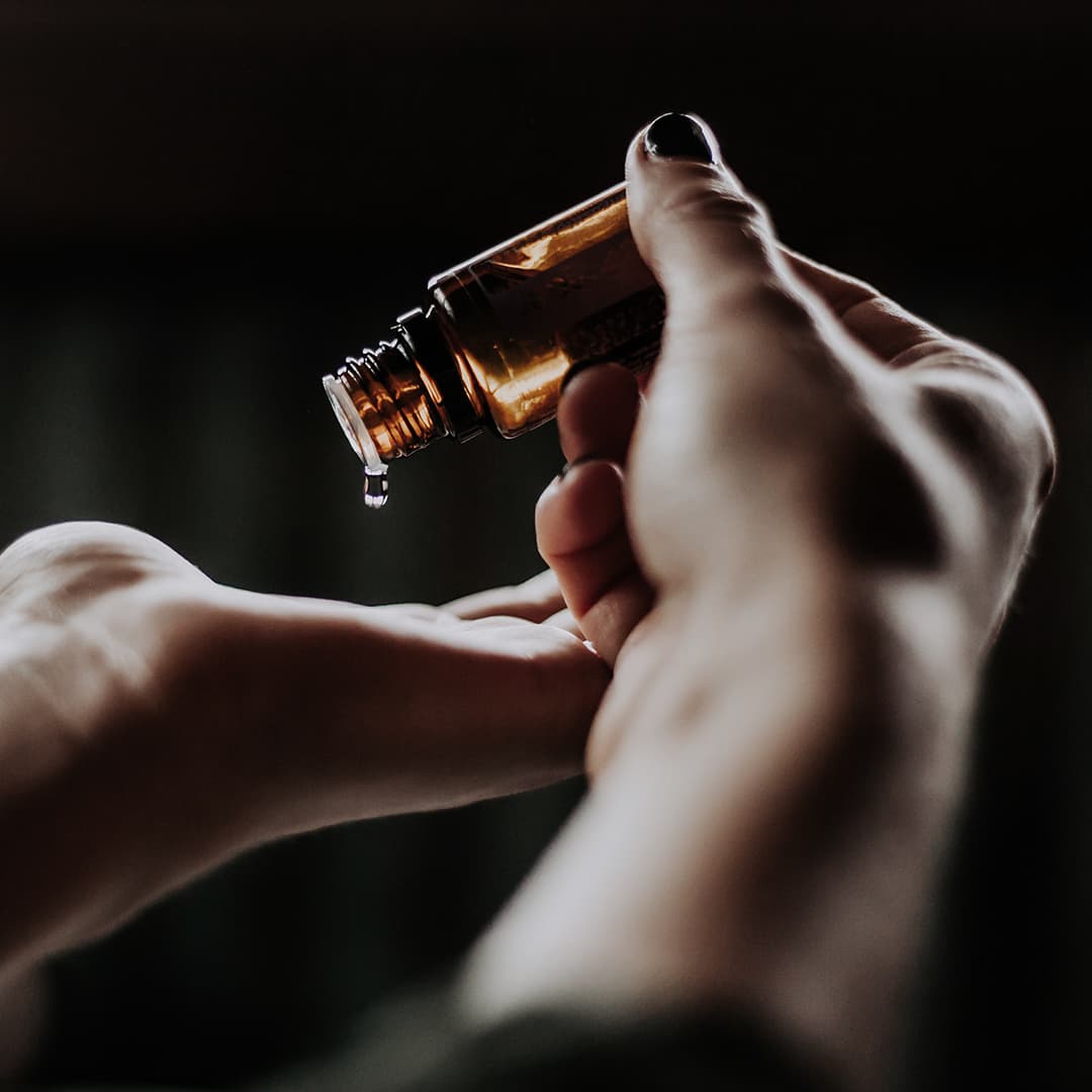 Bottle of serum pouring into hands