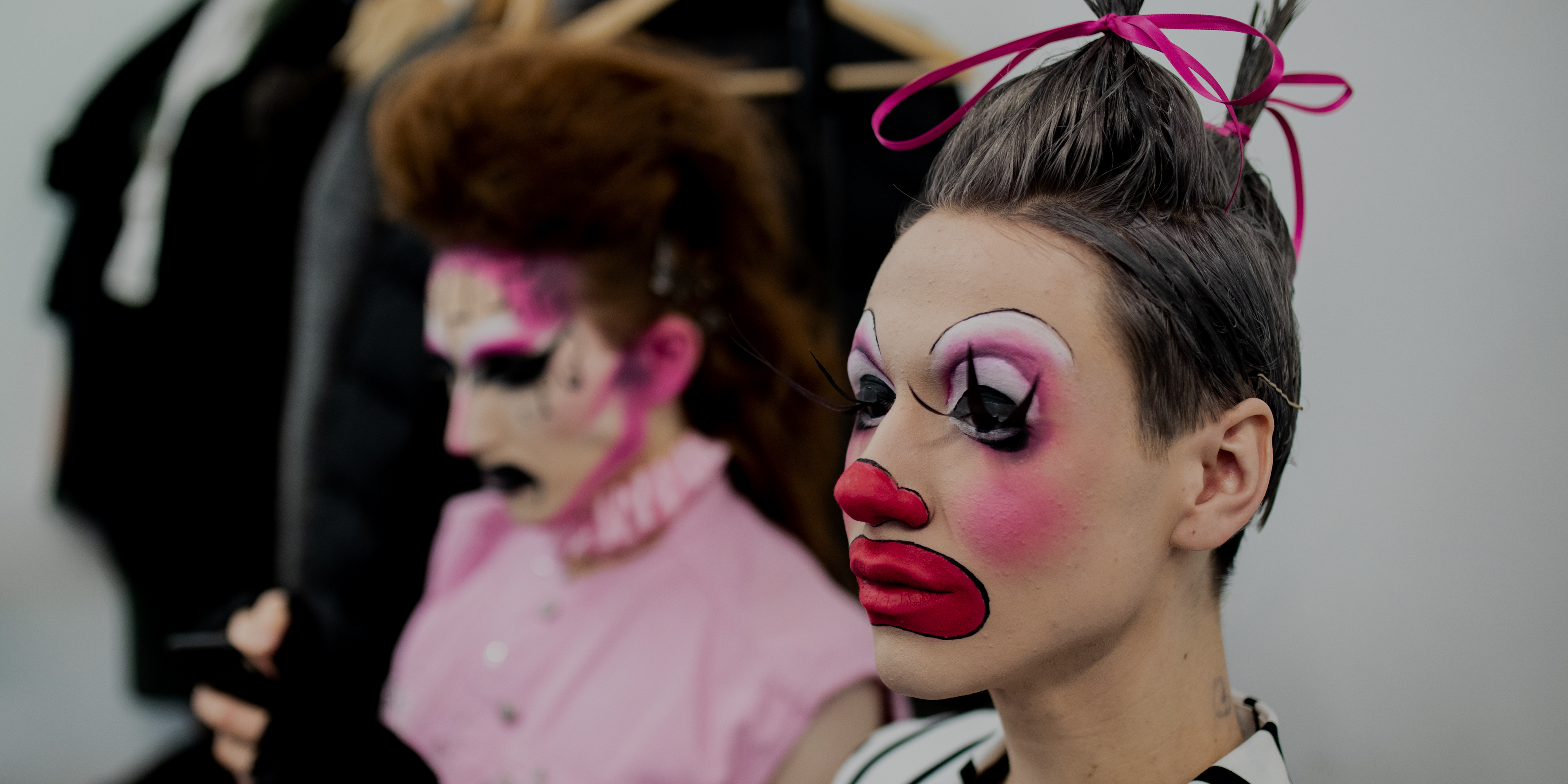 Two male models with clown makeup on