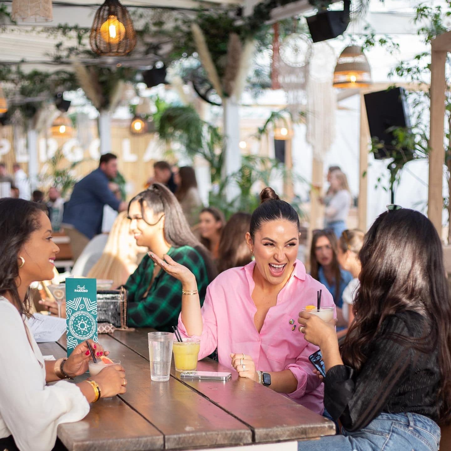 Guests at tables in Tulum inspired venue