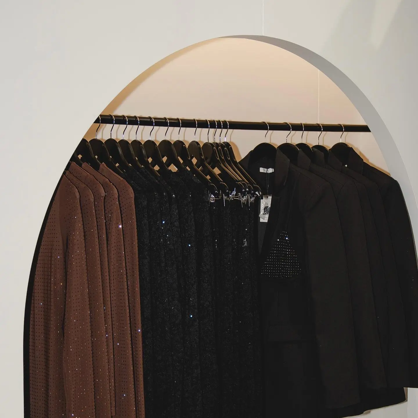 Rack of black and brown clothing on rack