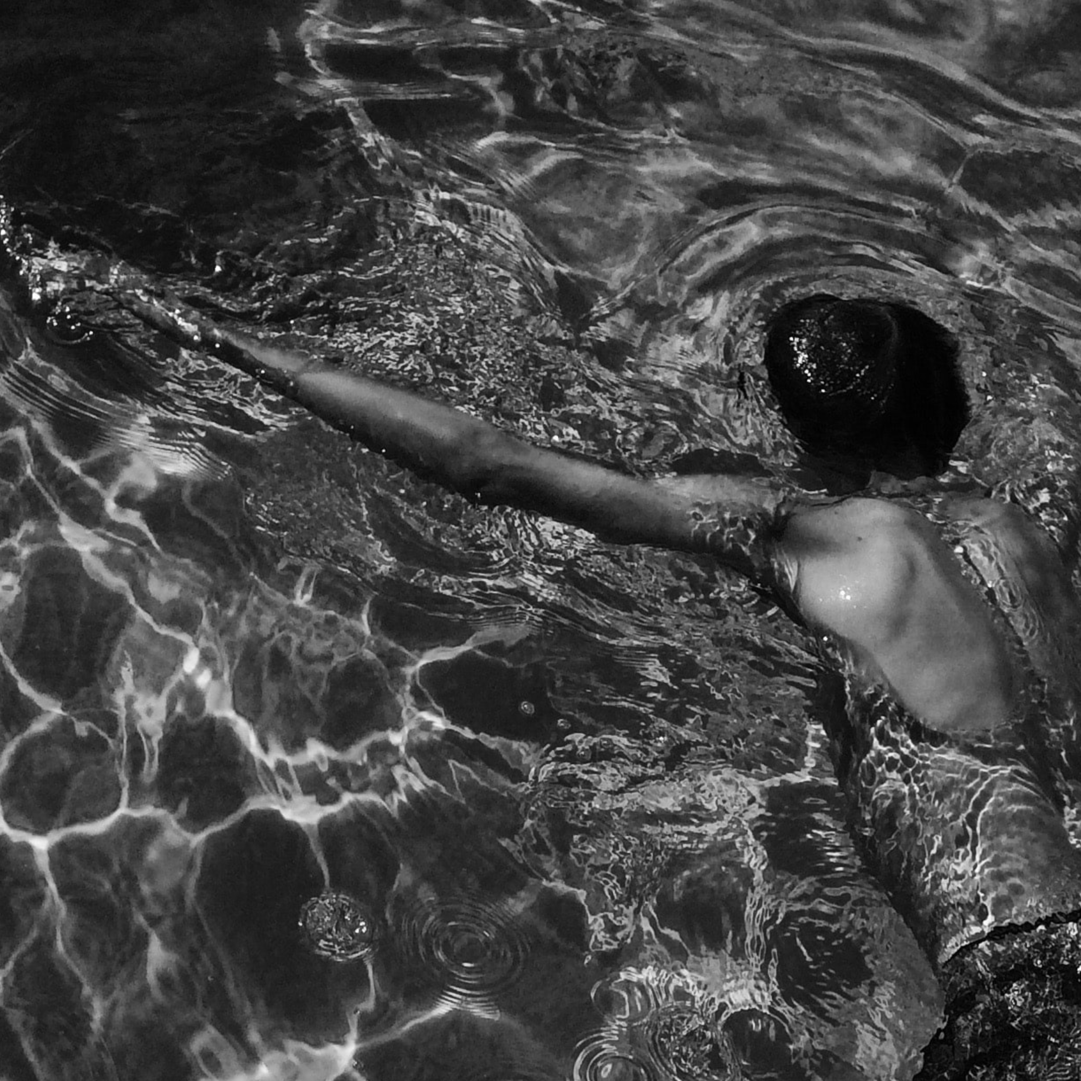 Black and white image on man swimming