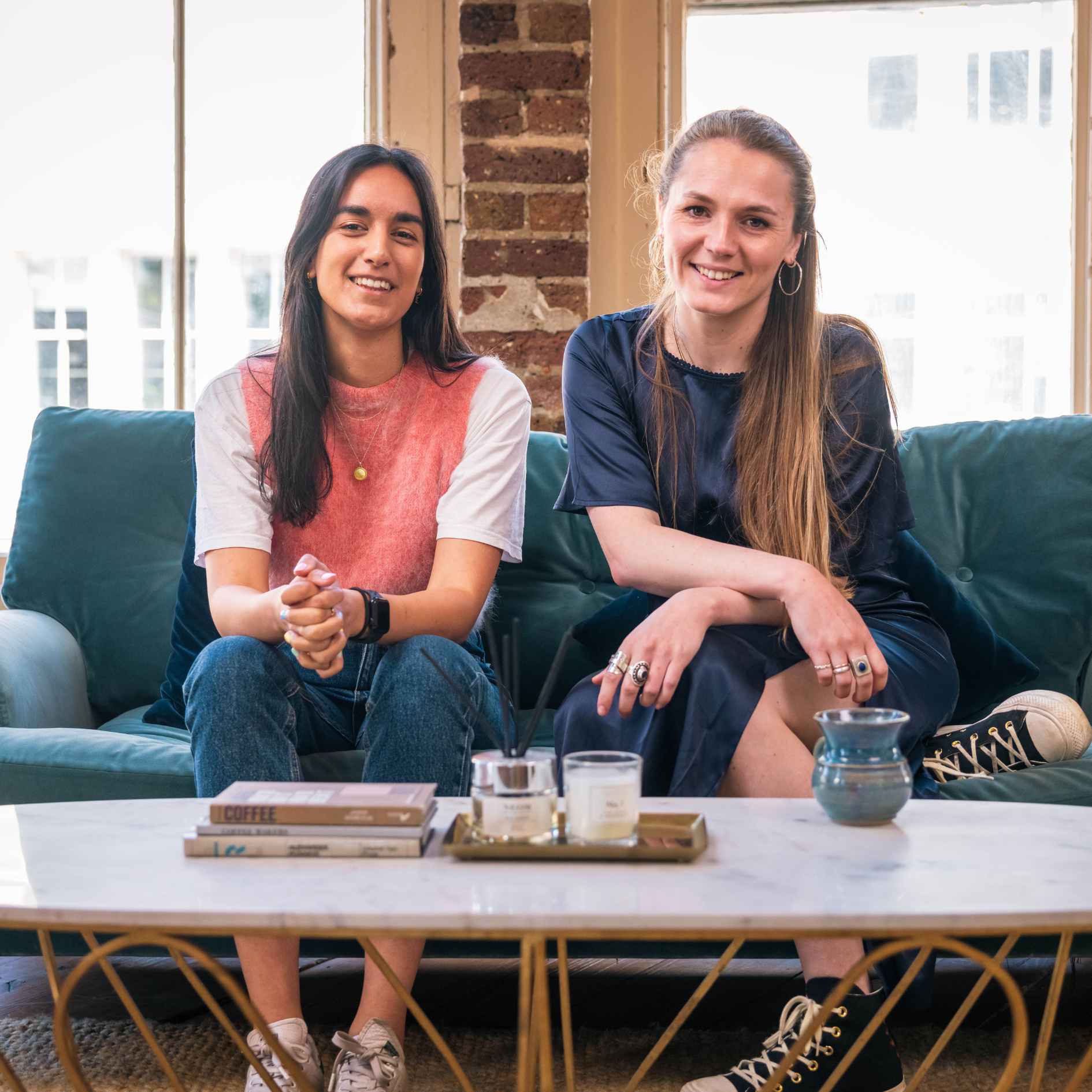 Two Marble team members sat on sofa