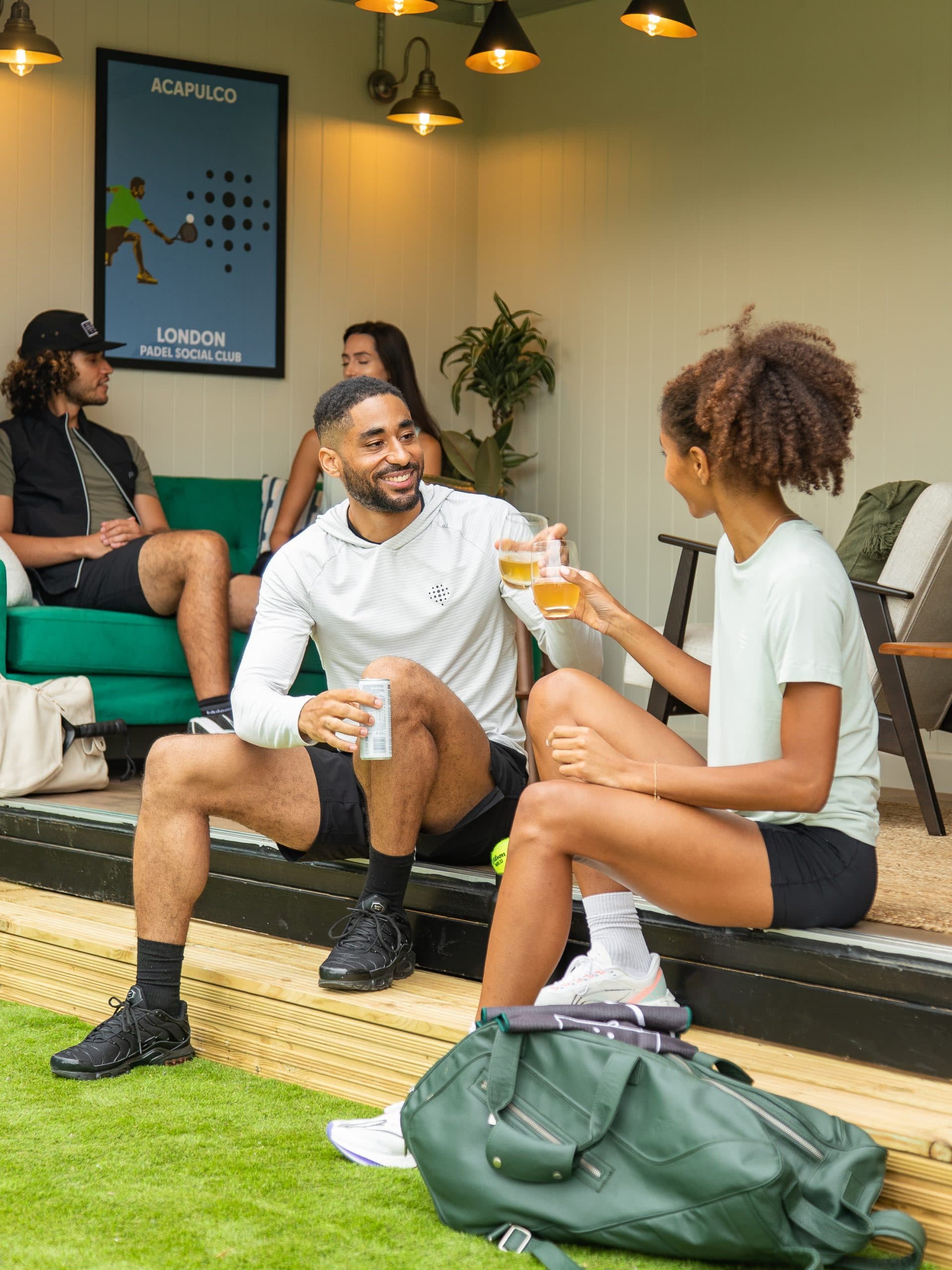 Two padel players sat chatting