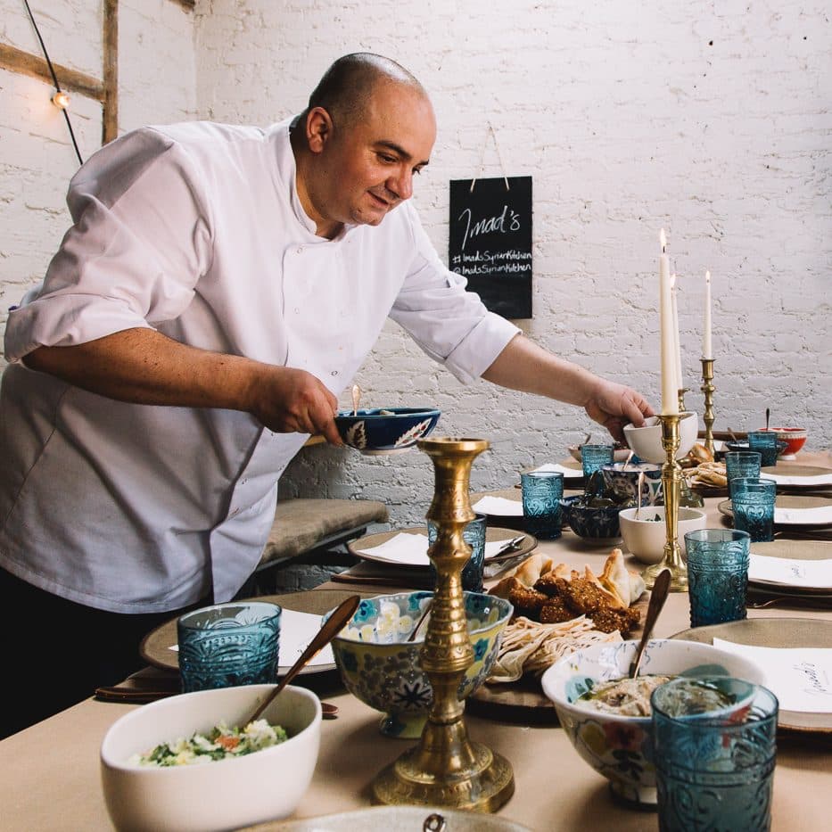 Imad Syrian Kitchen Chef Imad setting Syrian kitchen table